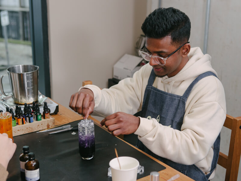 Man working with wax in a candle making workshop